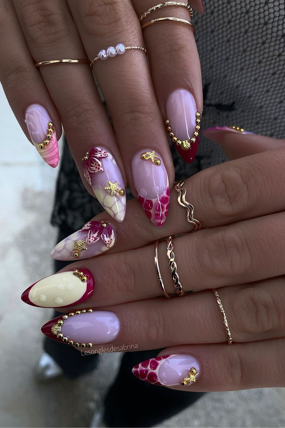 Red and yellow animal print nails with gold starfish and studs