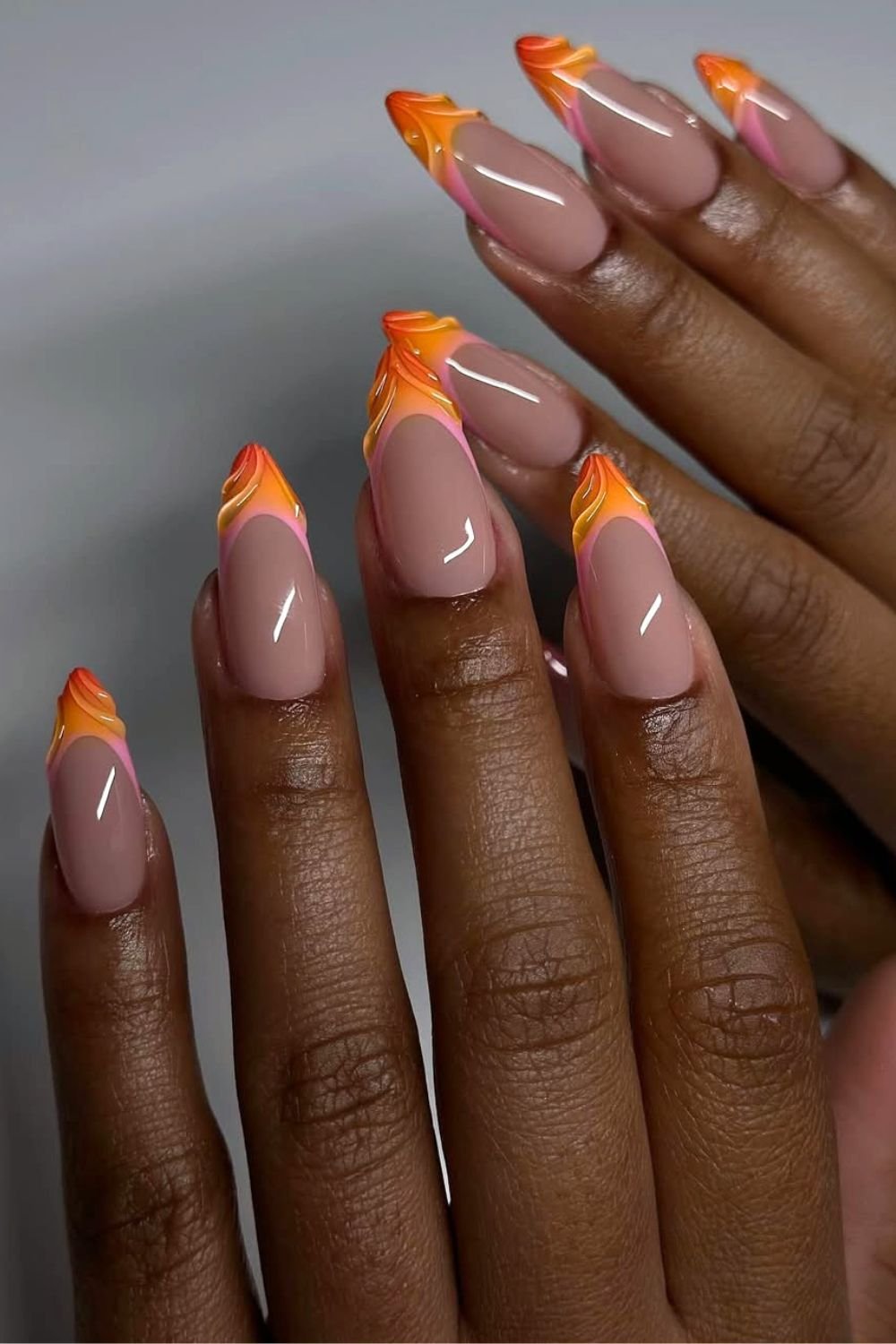 Textured dark orange to pink fade French nails