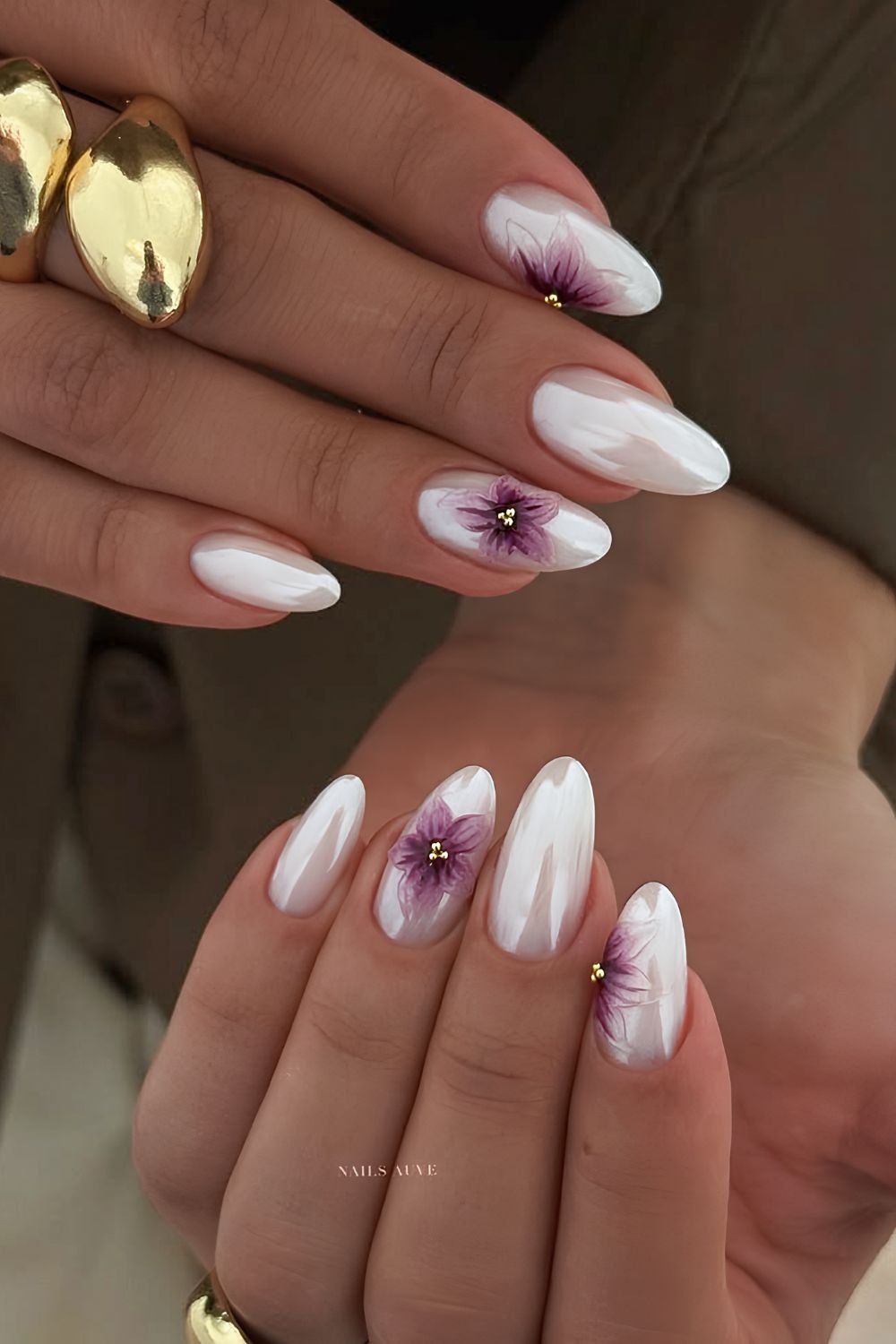 White chrome nails with textured purple floral accents