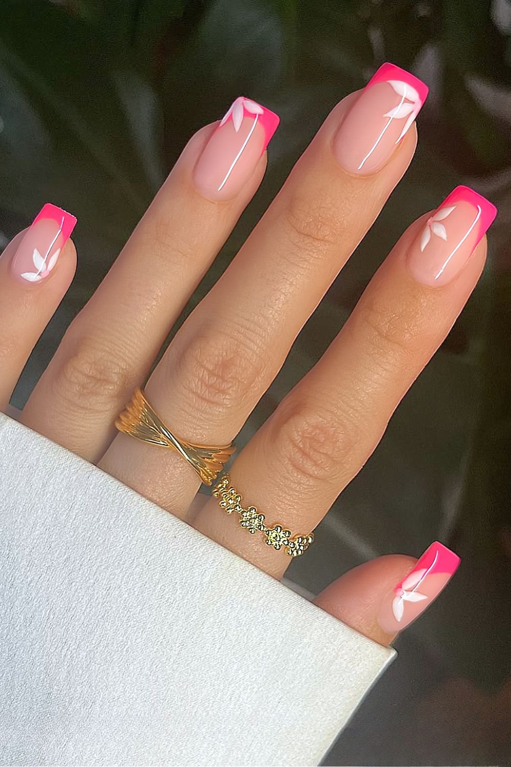 Hot pink French tip nails with white florals