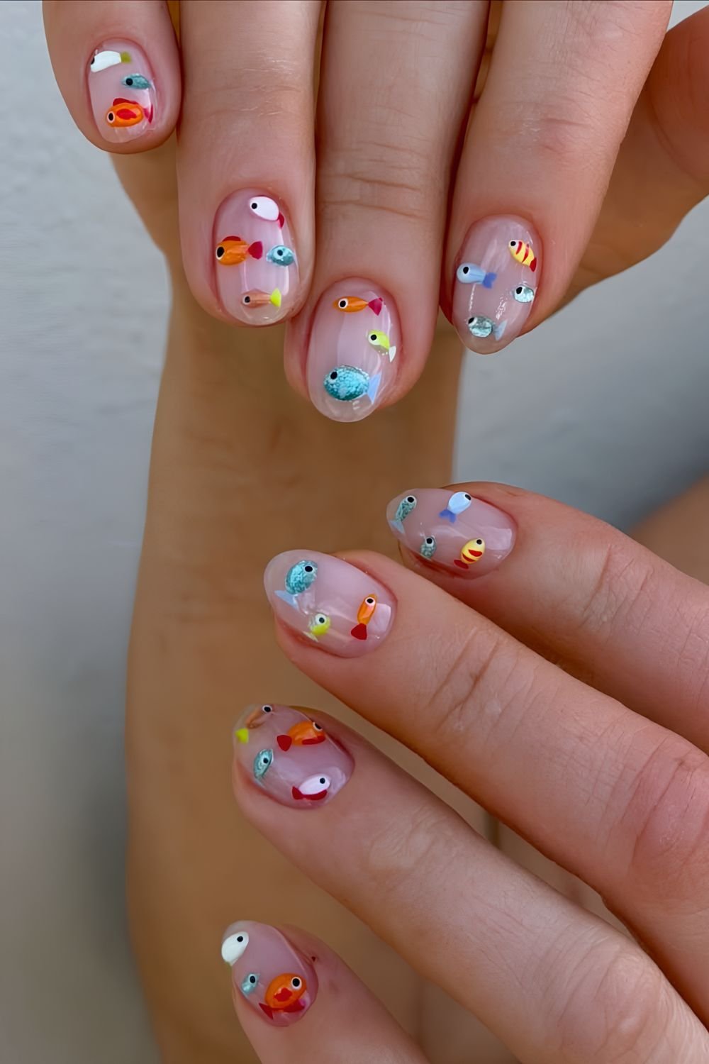 Neutral nails wit tiny fishes nail art