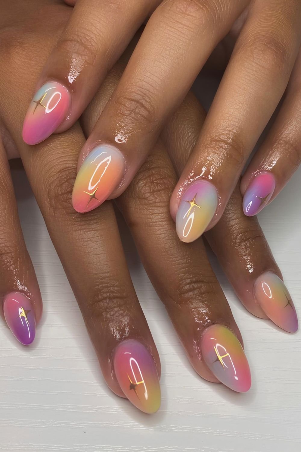 Rainbow ombre nails with gold starbursts