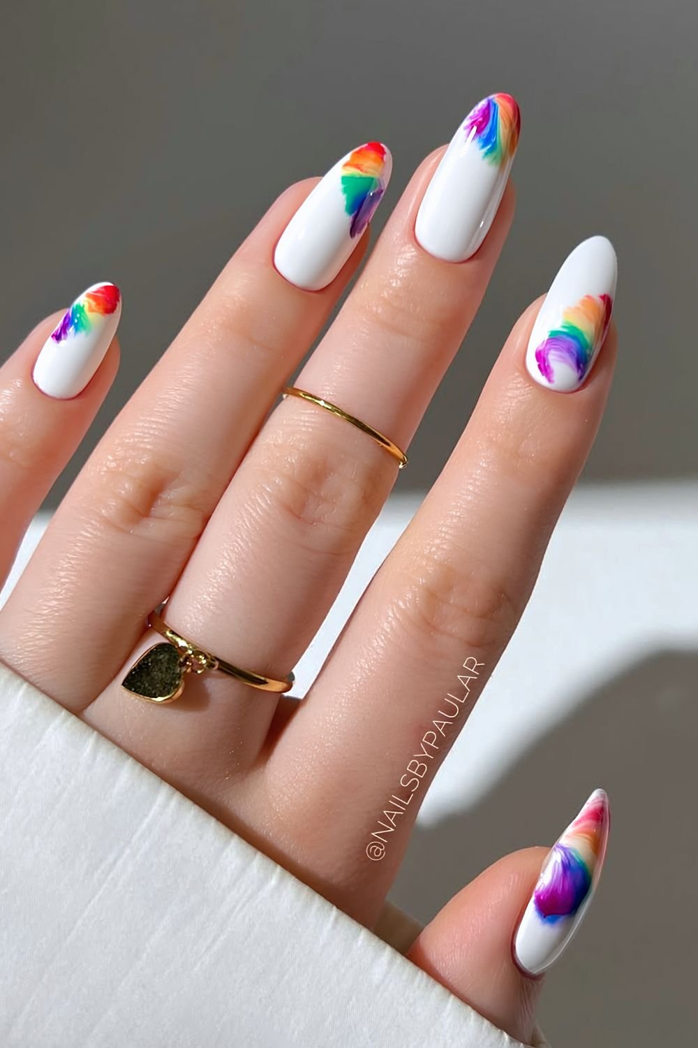 White nails with rainbow thread design