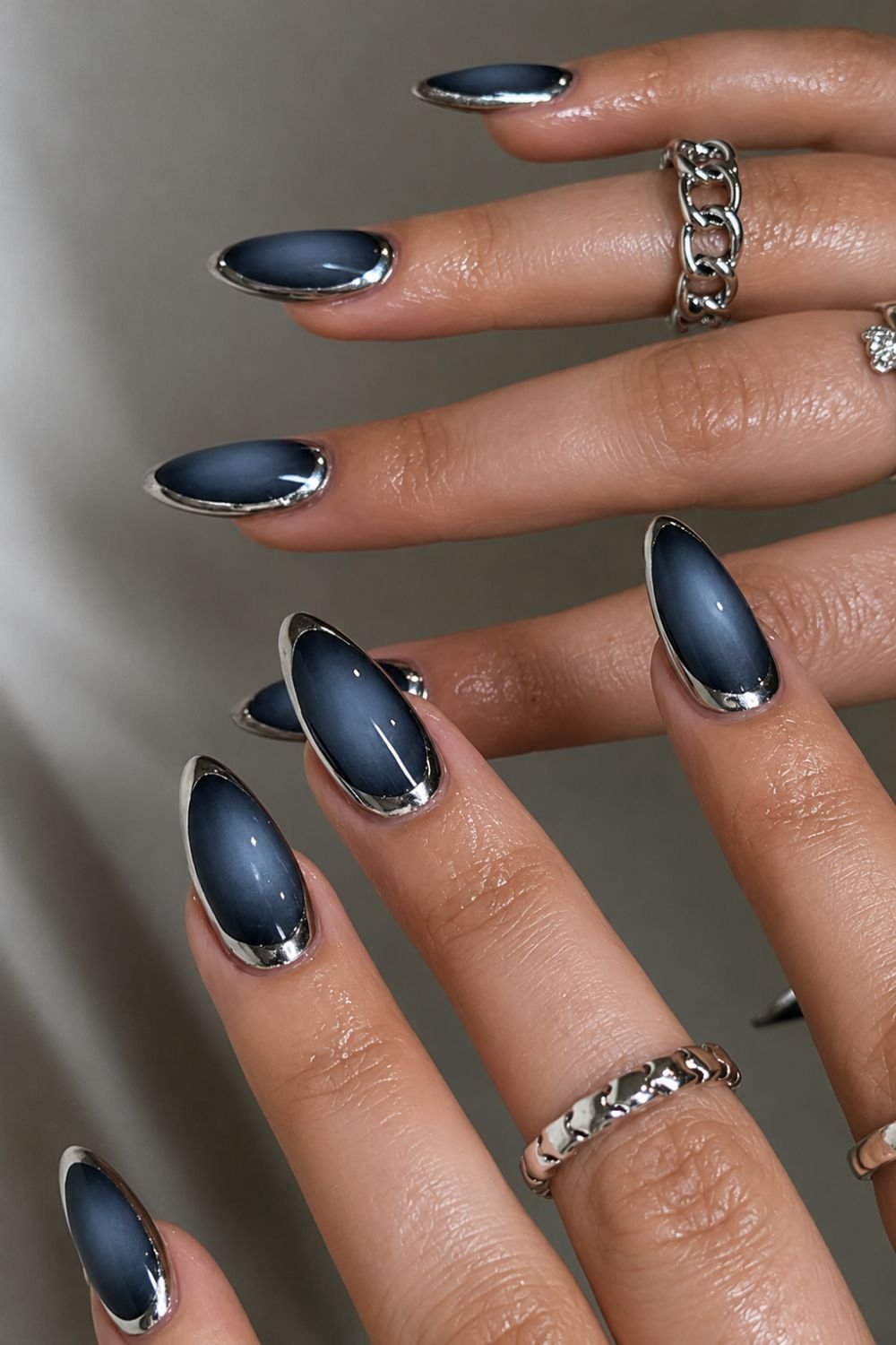 Dark blue with silver chrome aura nails