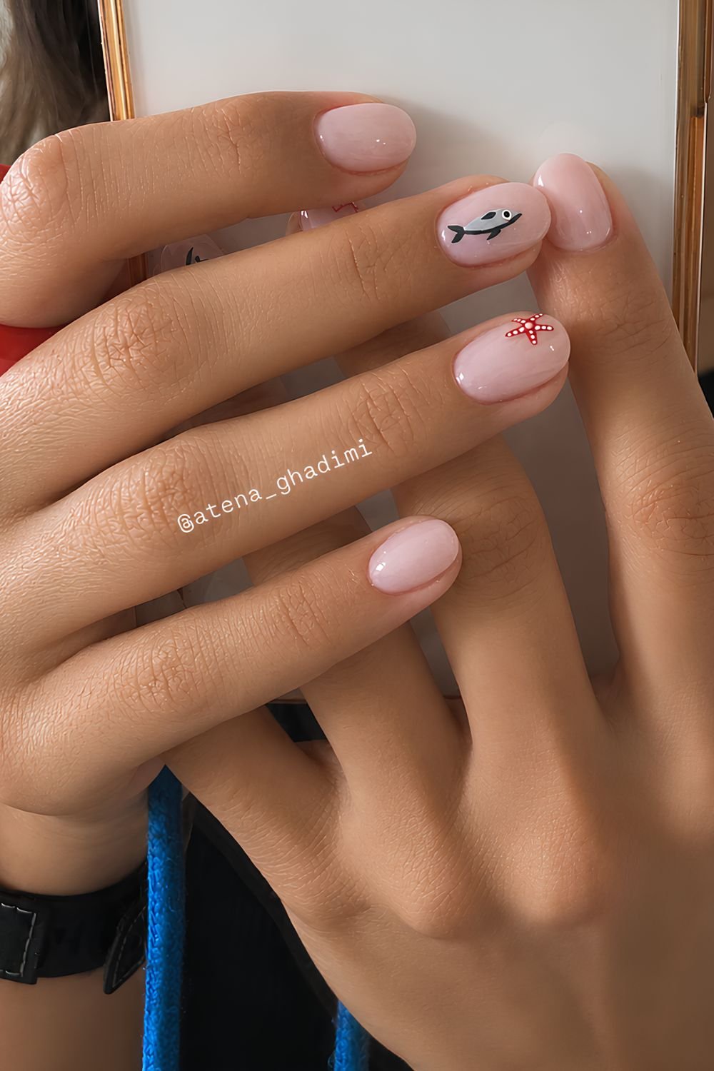 Milky pink nails with tiny starfish and fish design