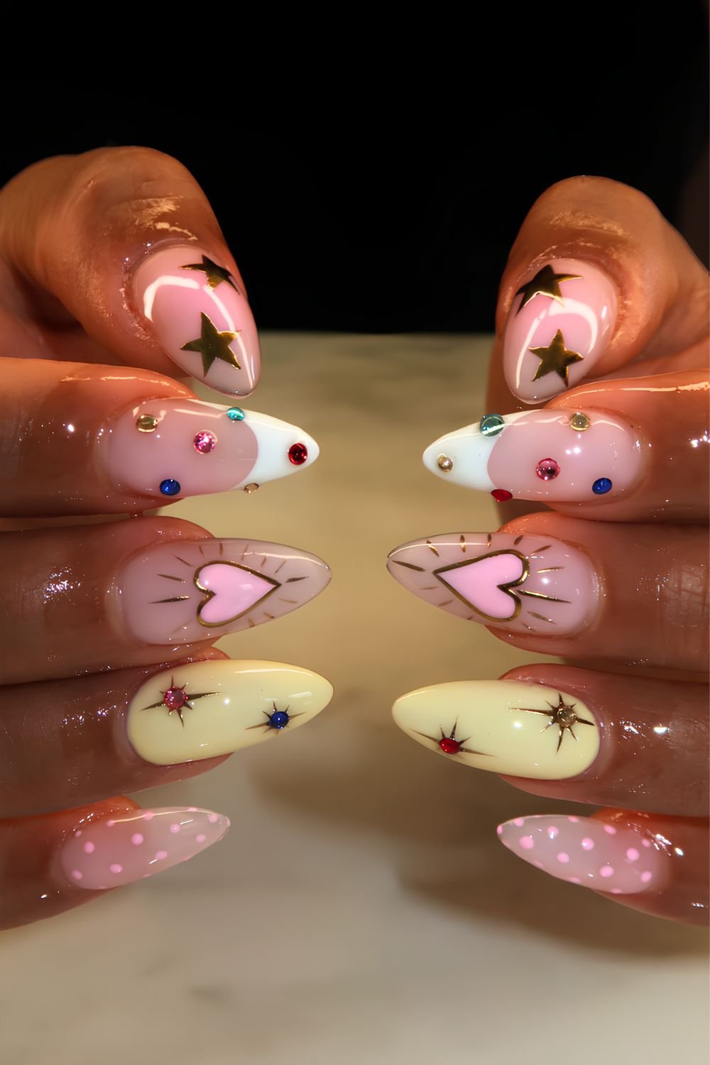 Mismatched nails with stars, hearts, gems and polkadots