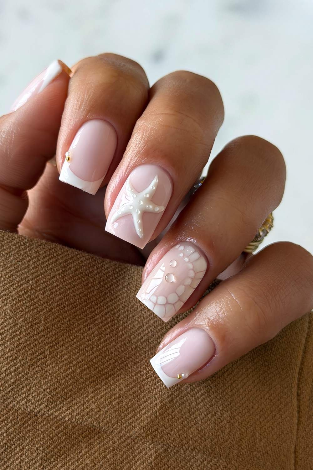 White French manicure with 3D starfish and and animal print accents