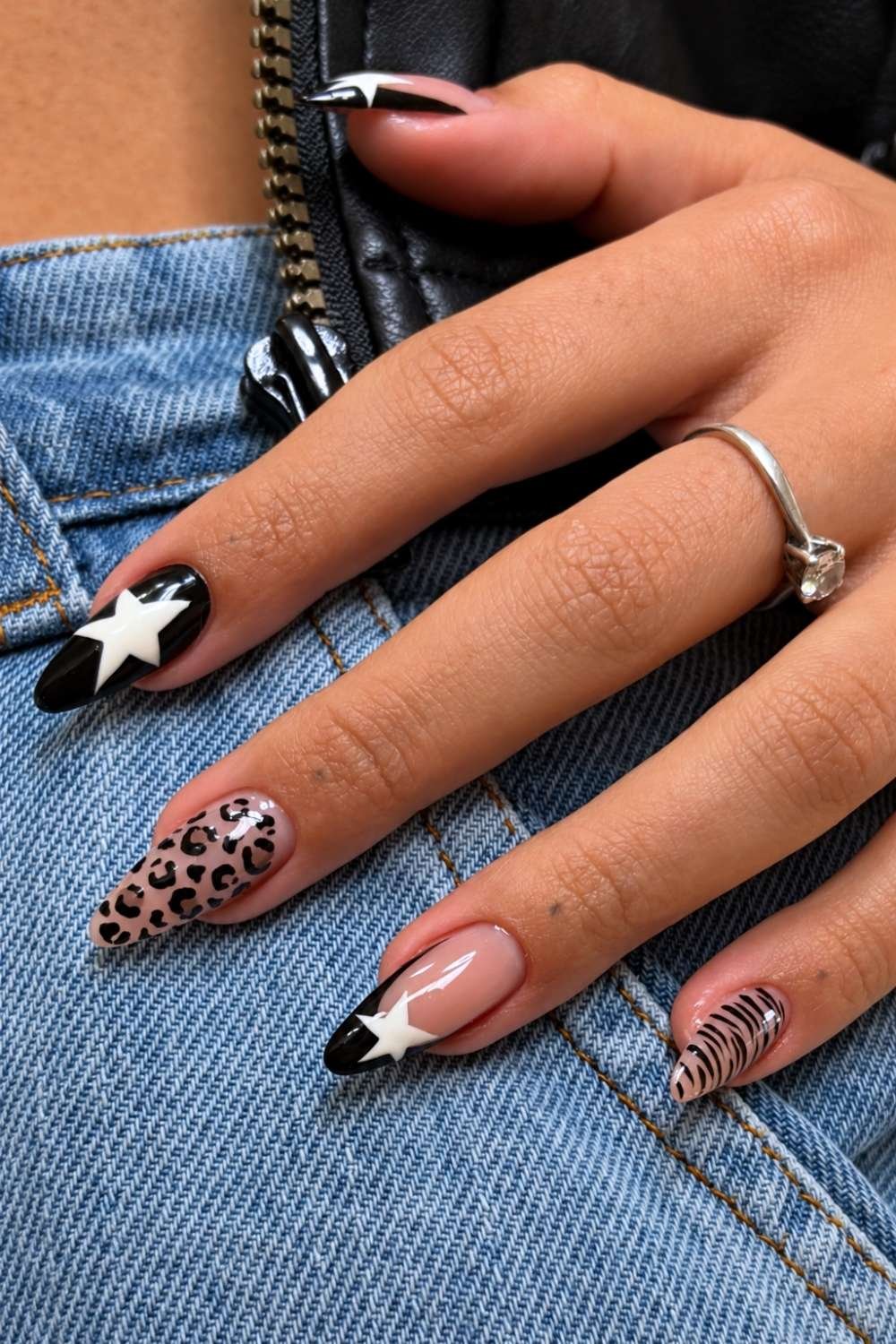 Black and white star nails with animal print accents