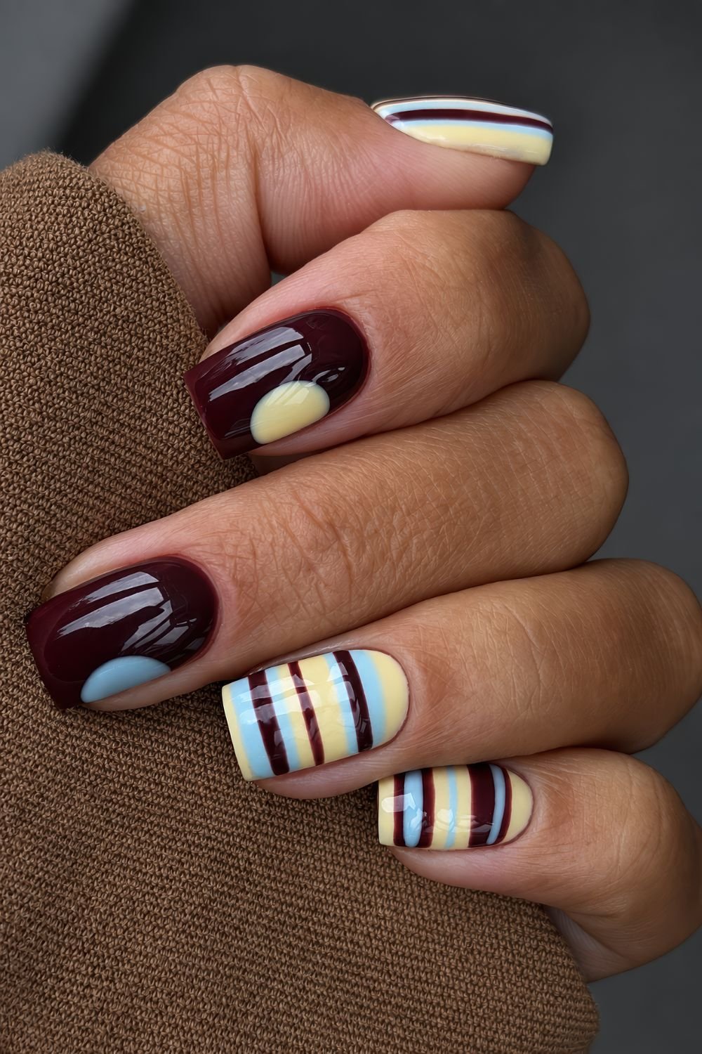 Brown, yellow and blue stripes and single dot nails