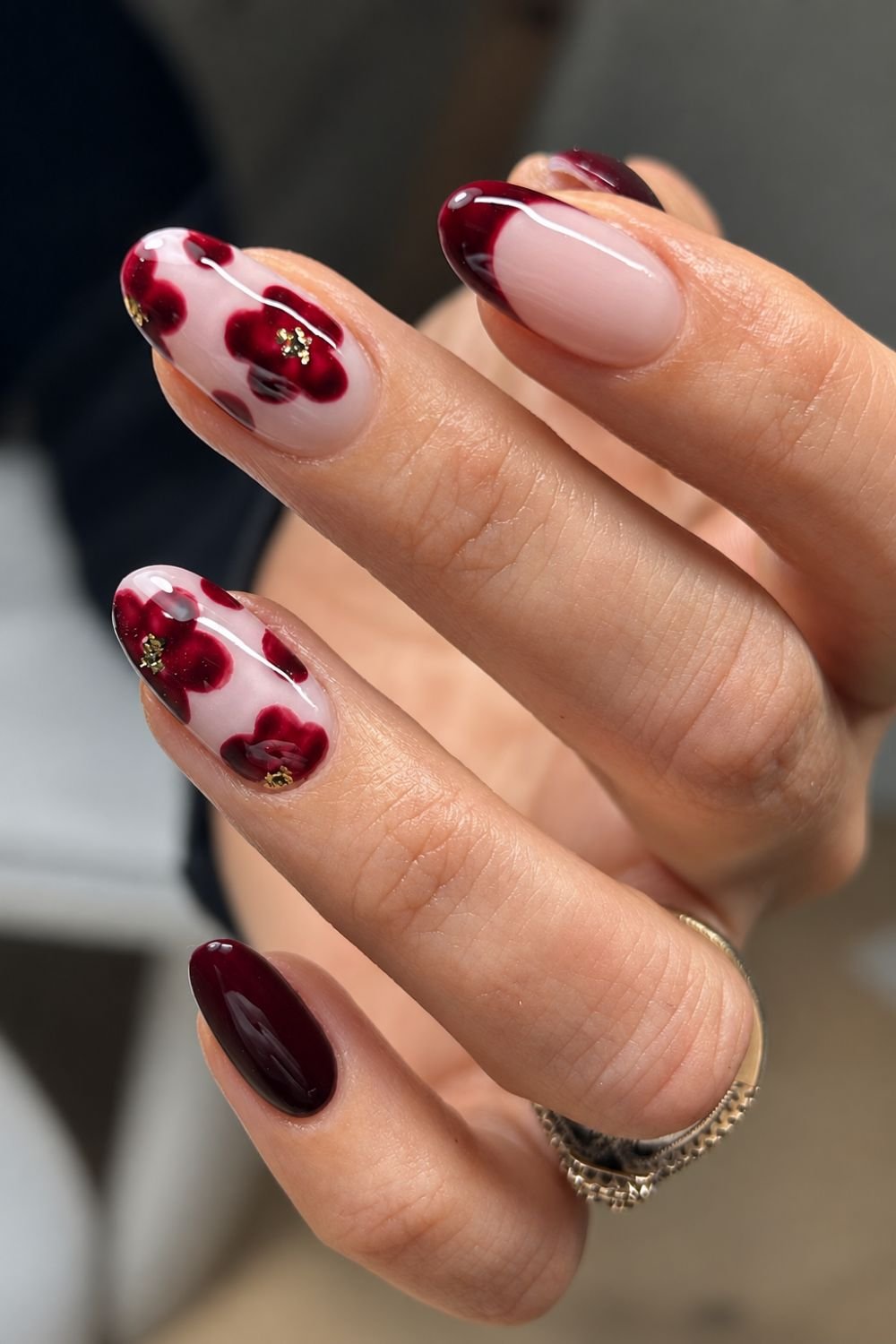 Burgudy nails with gold foil centered floral design