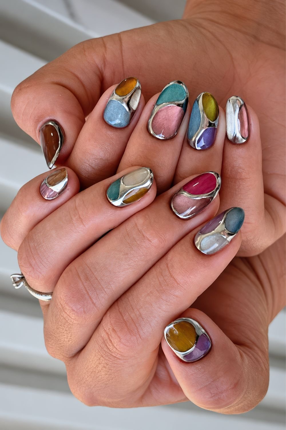 Multicolored cat eye and silver chrome mosaic nails