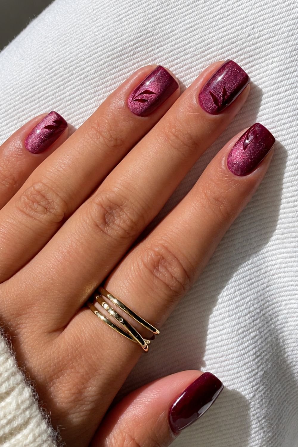 Red velvet nails with burgundy leaf nail art