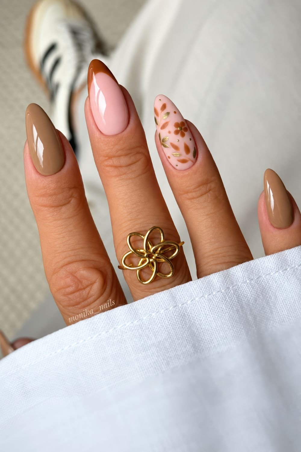 Taupe brown nails with caramel brown French tips and leaf accents